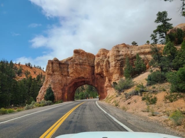 Driving through arch in Red Canyon State Park on our Utah road trip